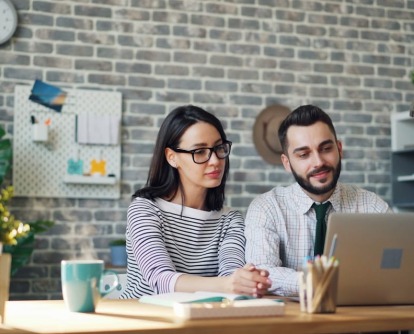 Man and women working alongside each other in office